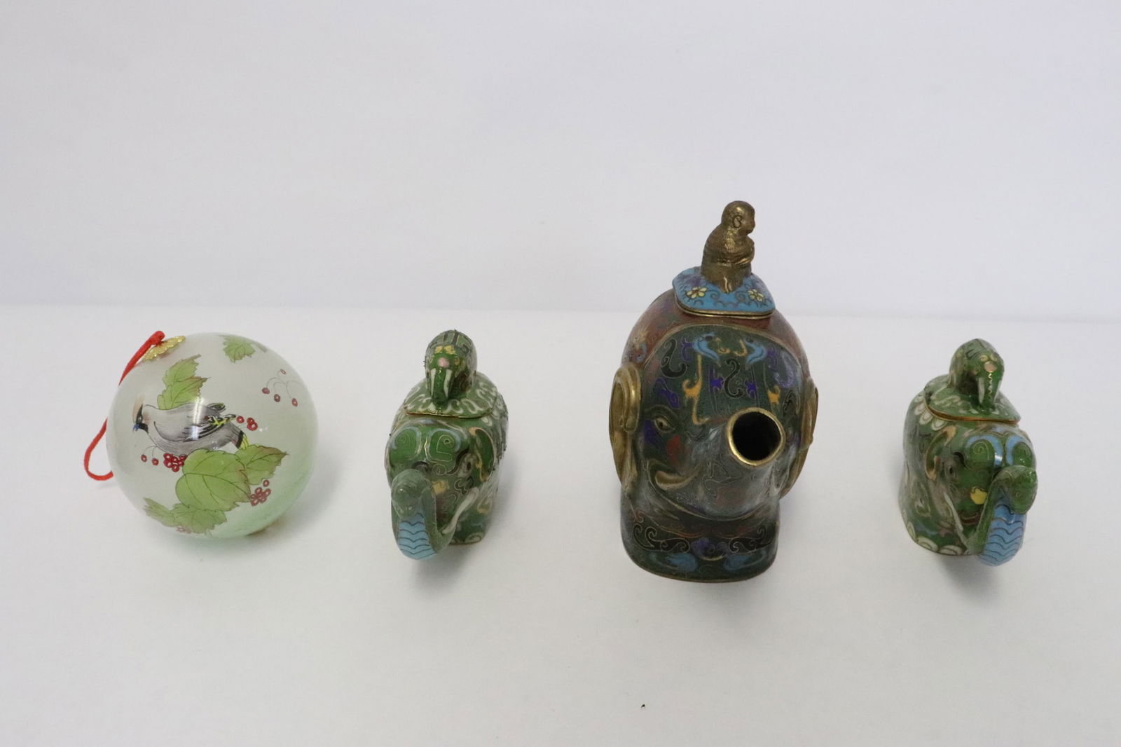 3 cloisonne pieces, & an inside painted glass ball: 4 pieces; cloisonne teapot in elephant motif (4.9"H), 2 cloisonne censers in elephant motif (3"H), and an inside painted glass ball (2.8"x2.8"dia)