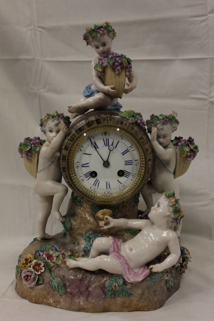 Germany antique porcelain table clock by Meissen: An important Germany antique key-wind porcelain table clock by Meissen, decorated with cherubs with grapes (16"x11"x9")