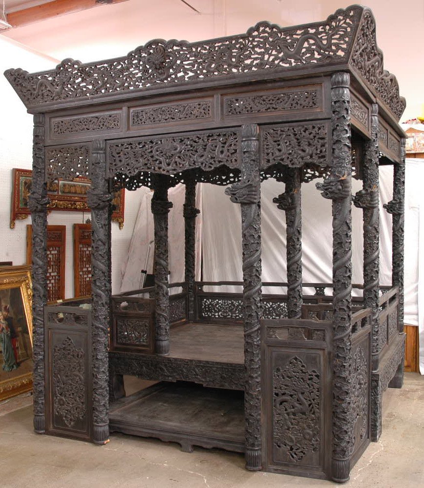 Chinese hardwood carved pedestal dragon bed: A magnificent Chinese hardwood carved pedestal dragon bed, with panels and columns decorated with dragons in cloud (92"Wx106"Hx97"D)