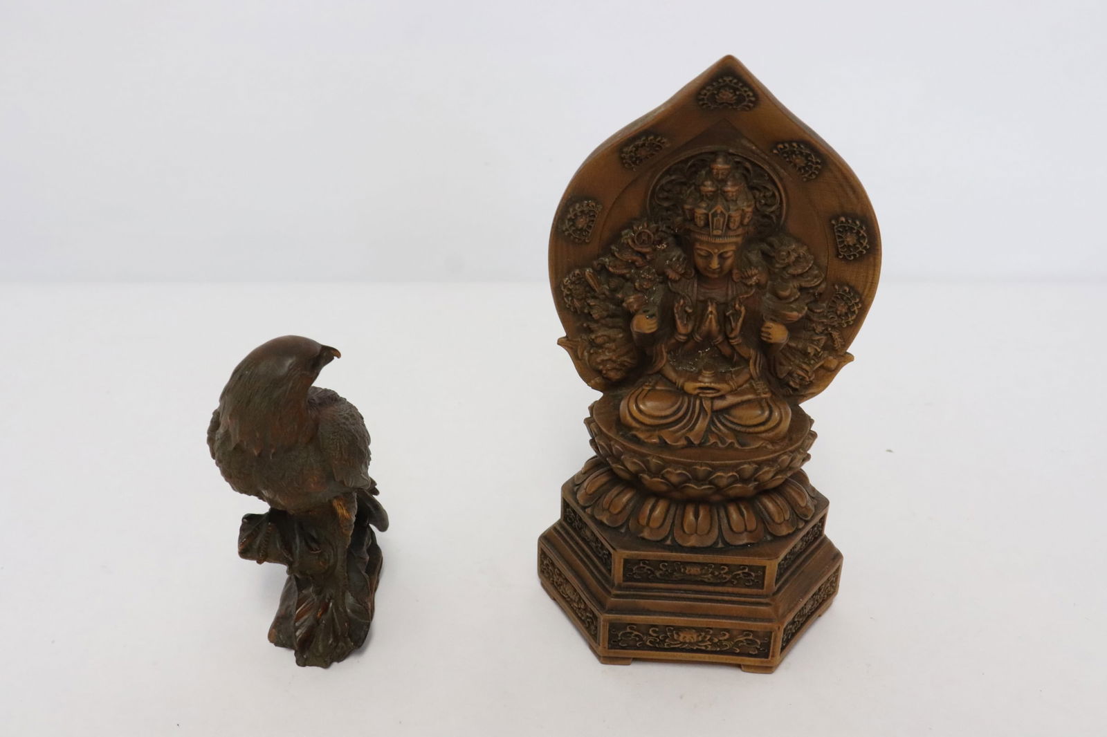 a wood(?) carved deity, and a wood carved eagle (1 of 11)