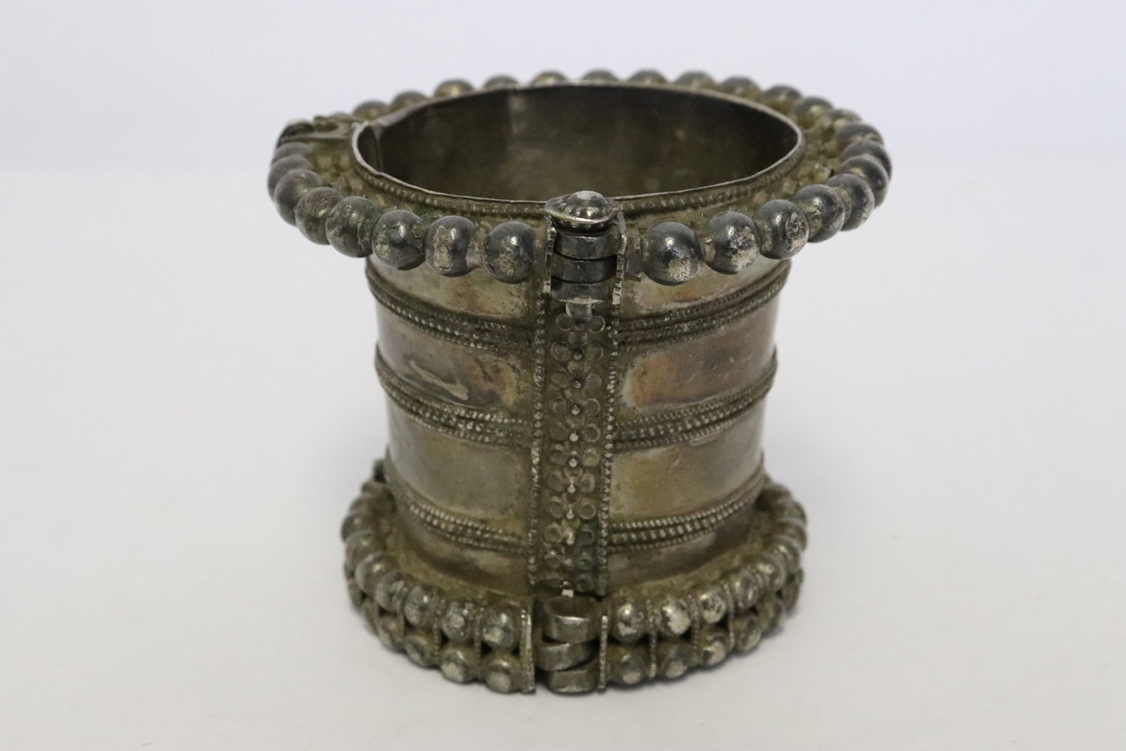A Tibetan(?) silver cuff (?): A Tibetan(?) silver (tested positive for silver, content unknown) cuff (?), wt. 256gm, 2.65"x3.2"dia