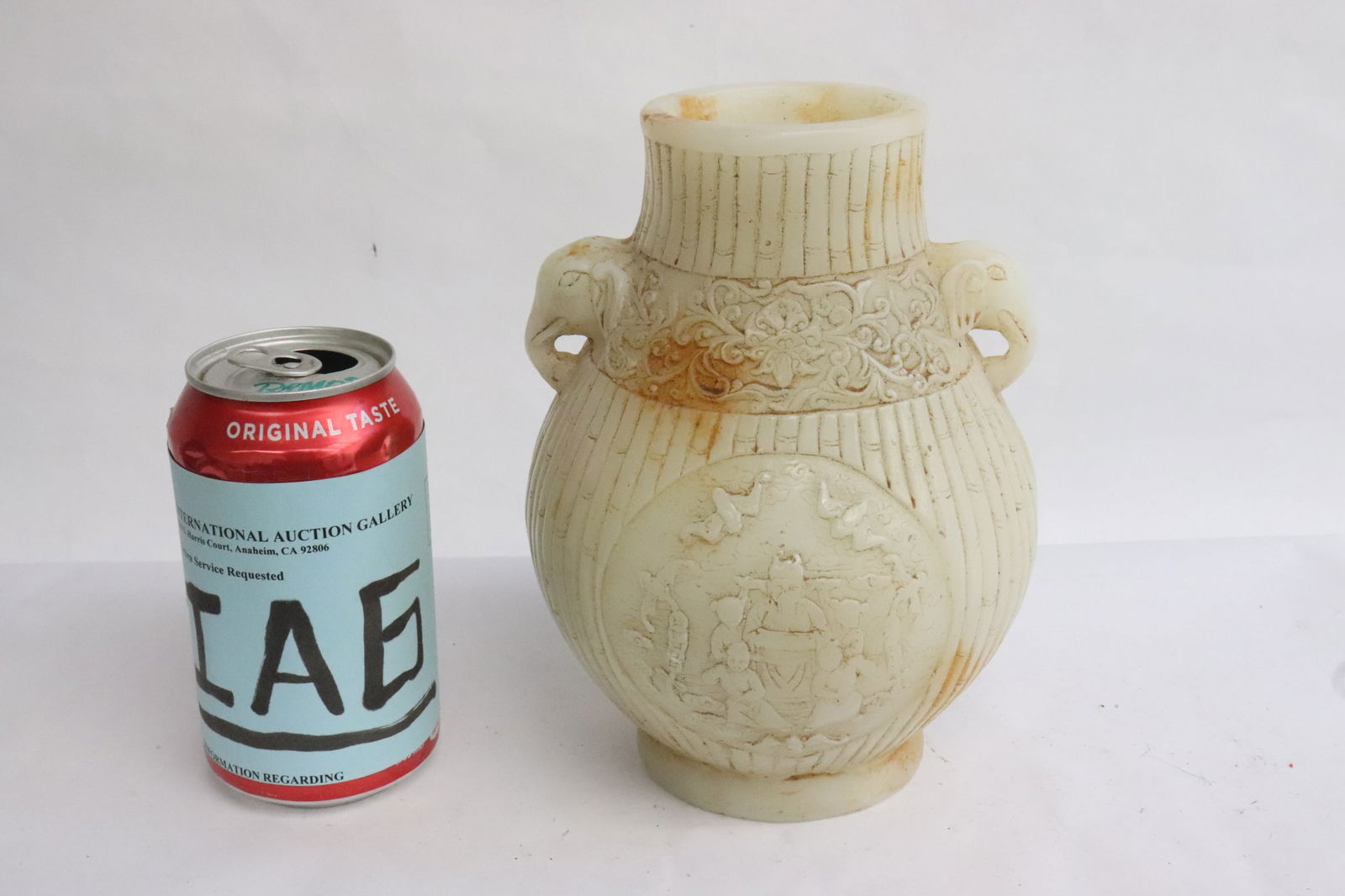 A Chinese vintage white Peking glass jar: A Chinese vintage white Peking glass jar with elephant motif handles, 7.3"x5.5"dia