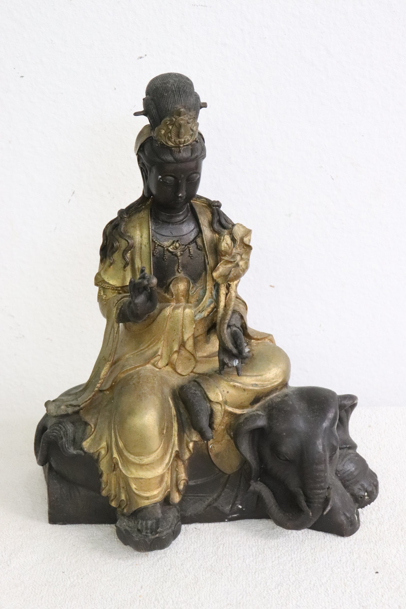 Chinese parcel gilt bronze sculpture: Fine Chinese parcel gilt bronze sculpture of deity with base in elephant motif, 11.35"H