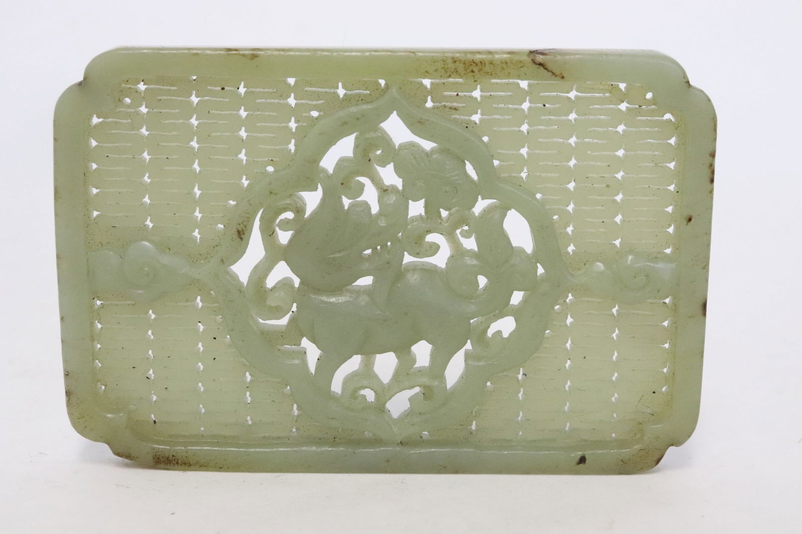 A celadon jade plaque: A celadon jade plaque, 0.25"x3.7"x2.49"