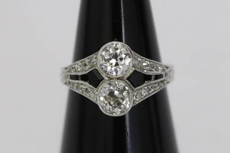 platinum deco diamond ring: Beautiful platinum deco diamond ring, center 2 old European cut diamonds, each wt. approx. 0.67ct (measures approx. 5.3x3.4mm) in VS2/SI1, G/H quality, accented with 16 small diamonds, tdw approx. 1.5