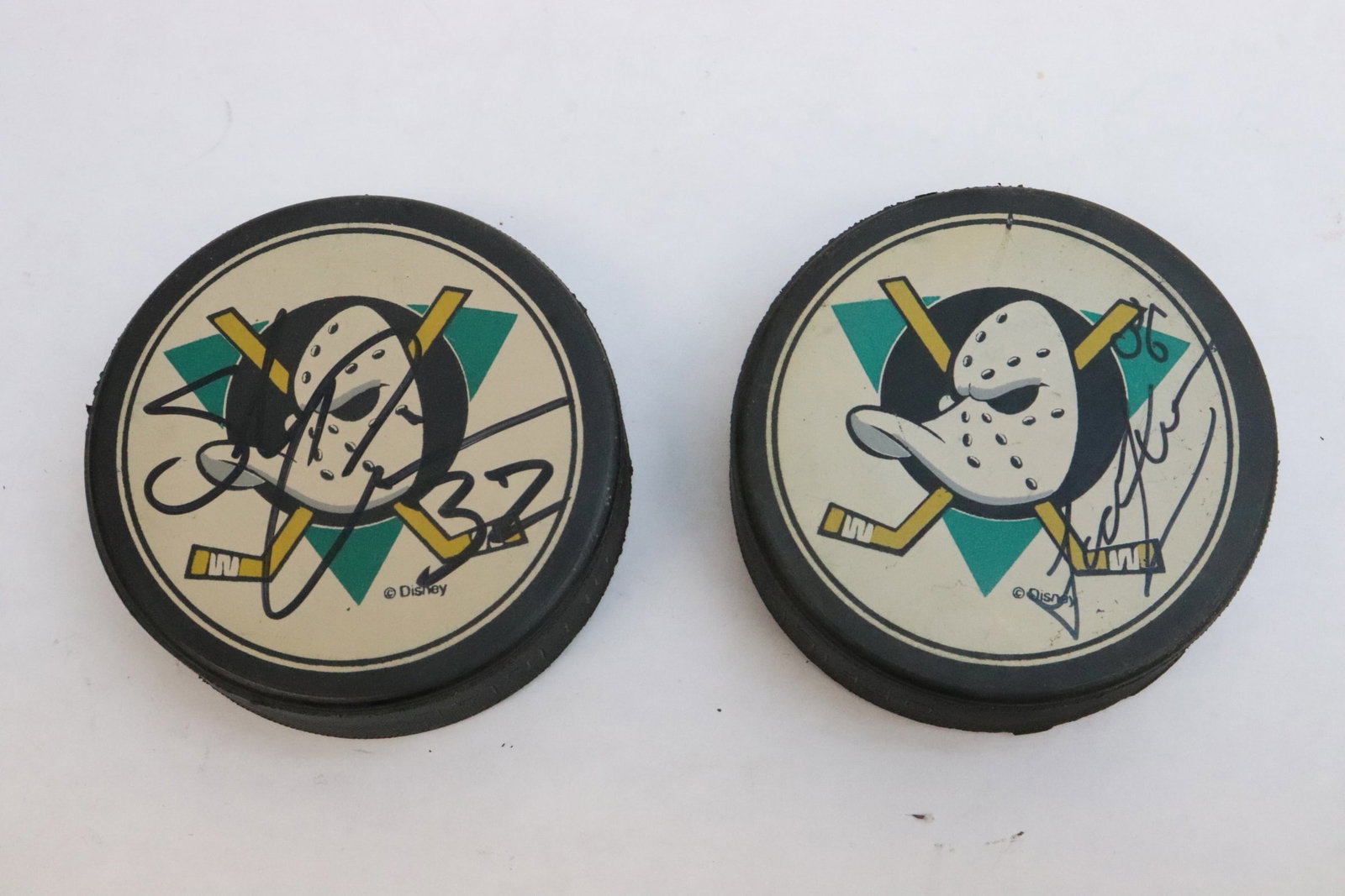 2 signed hockey pucks: 2 signed hockey pucks