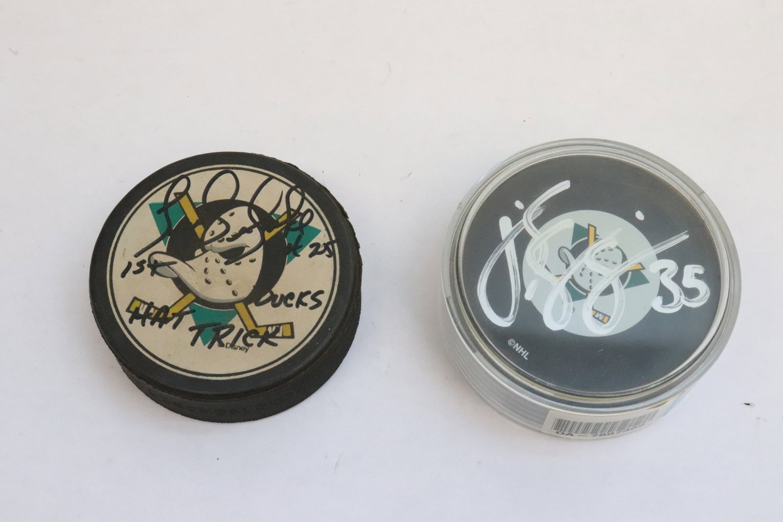 2 signed hockey pucks: 2 signed hockey pucks