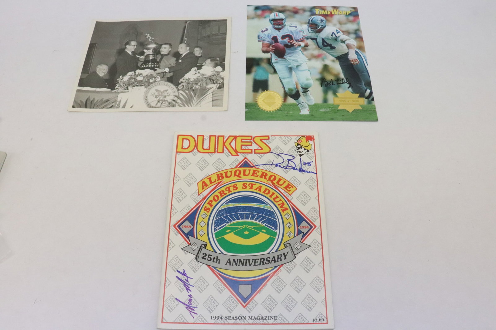 3 pieces: 3 pieces; Bob Lilly signed photo, a vintage football player photo, and a double signed Duck 1994 season magazine