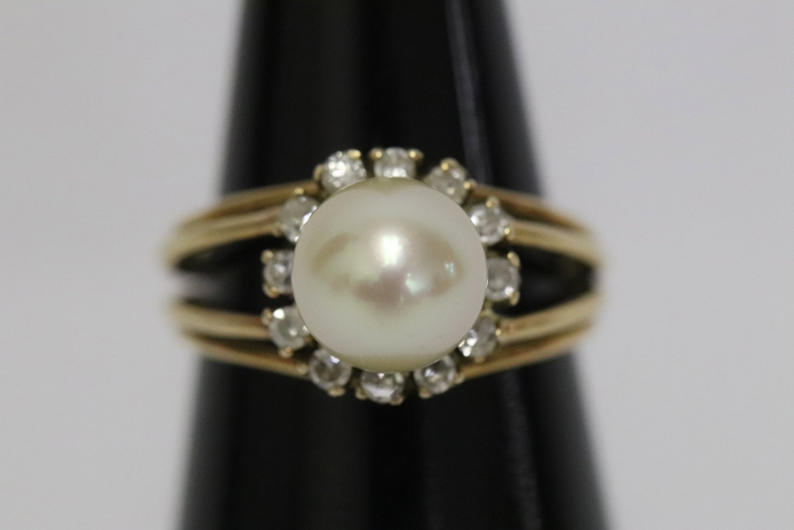 18K Y/G cultured pearl diamond ring: 18K Y/G cultured pearl diamond ring set with a cultured pearl measures approx. 8.1mm diameter, accented with 12 small diamonds, wt. 4.6gm, size 6