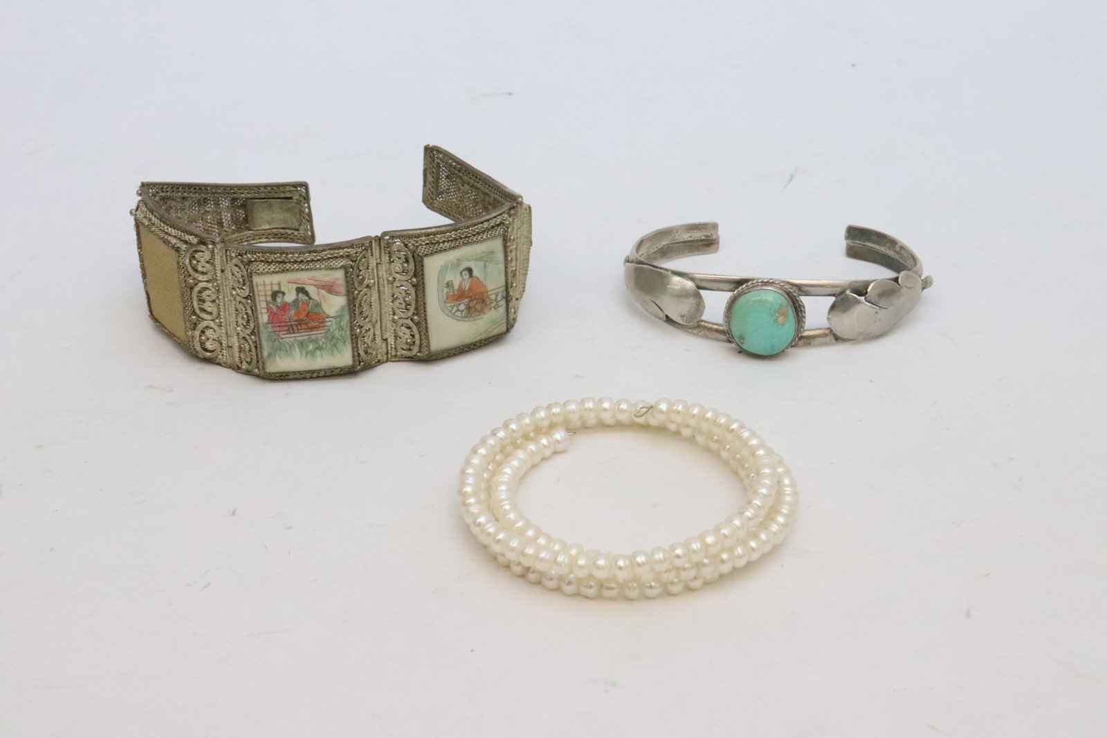 3 bracelets: 3 bracelets; including one flexible pearl bracelet (20.2"L), the Chinese bracelet (0.5"x1.25"x6.75") missing one plaque, and the clasp need repair