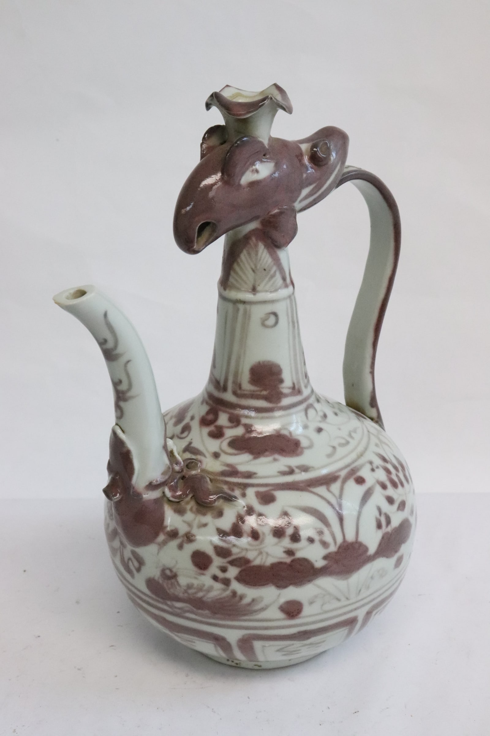 A red and white porcelain wine server: A red and white porcelain wine server, 9.2"x6.5"x5.2"