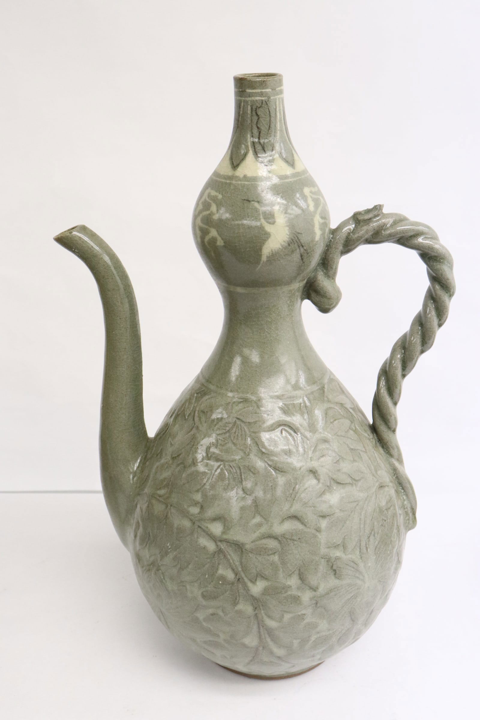 A vintage Korean celadon wine server: A vintage Korean celadon wine server, top of the handle chip, 12.85"x8.2"x6.2"