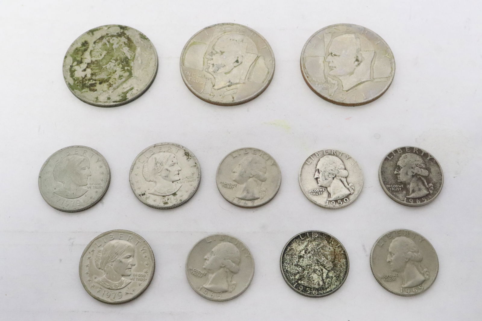 6 US quarters, 3 Eisenhauer dollars, & 3 Susan Anthony dollars: 6 US quarters (1950, 1956 1965(3), and 1967), and 3 Eisenhauer dollars (1971(2), 1972), and three 1979 Susan Anthony dollars