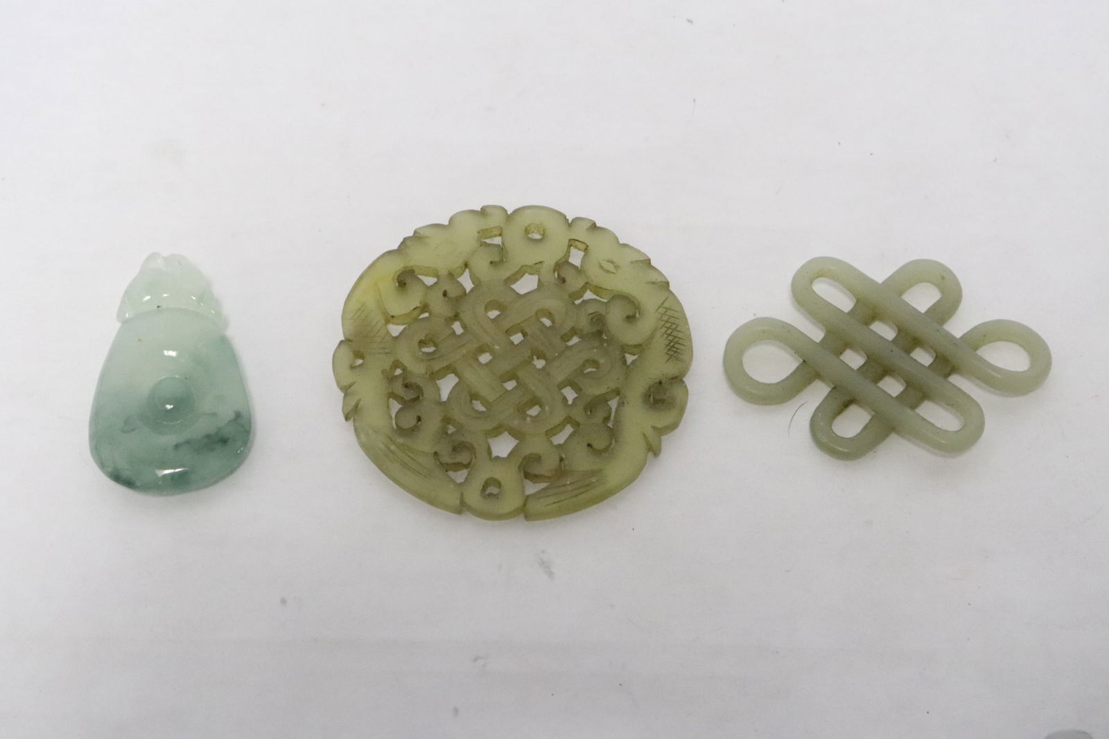 3 Chinese jade/ jadeite carved ornaments: 3 Chinese jade/ jadeite carved ornaments, 0.3"x1.65"x0.95" - 0.15"x2.25"dia