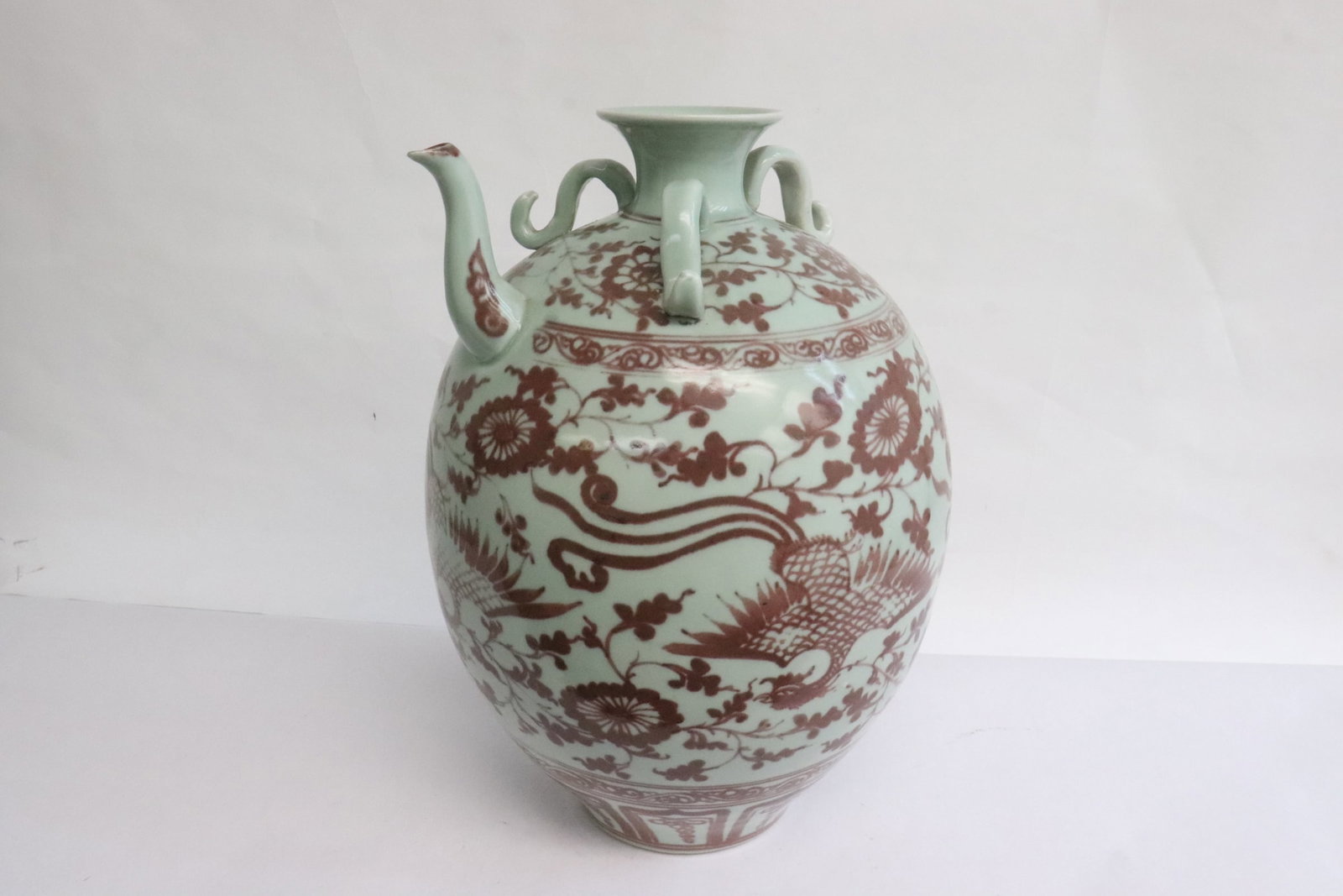 A red and white porcelain wine server: A red and white porcelain wine server, 12.3"x8.75"x8.65"