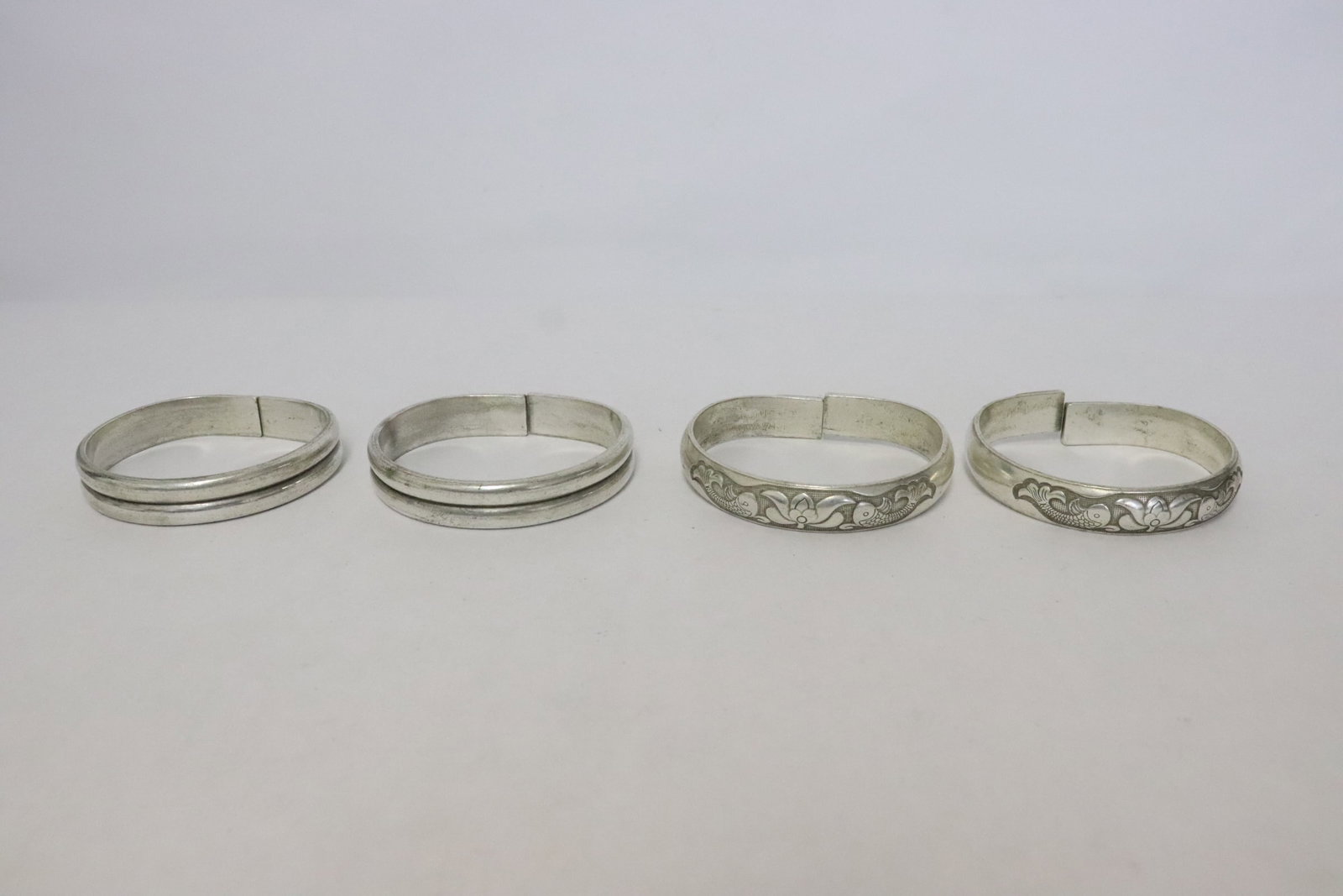 4 white metal bangles: 4 white metal bangles, 0.5"x2.6"x2.9" ea