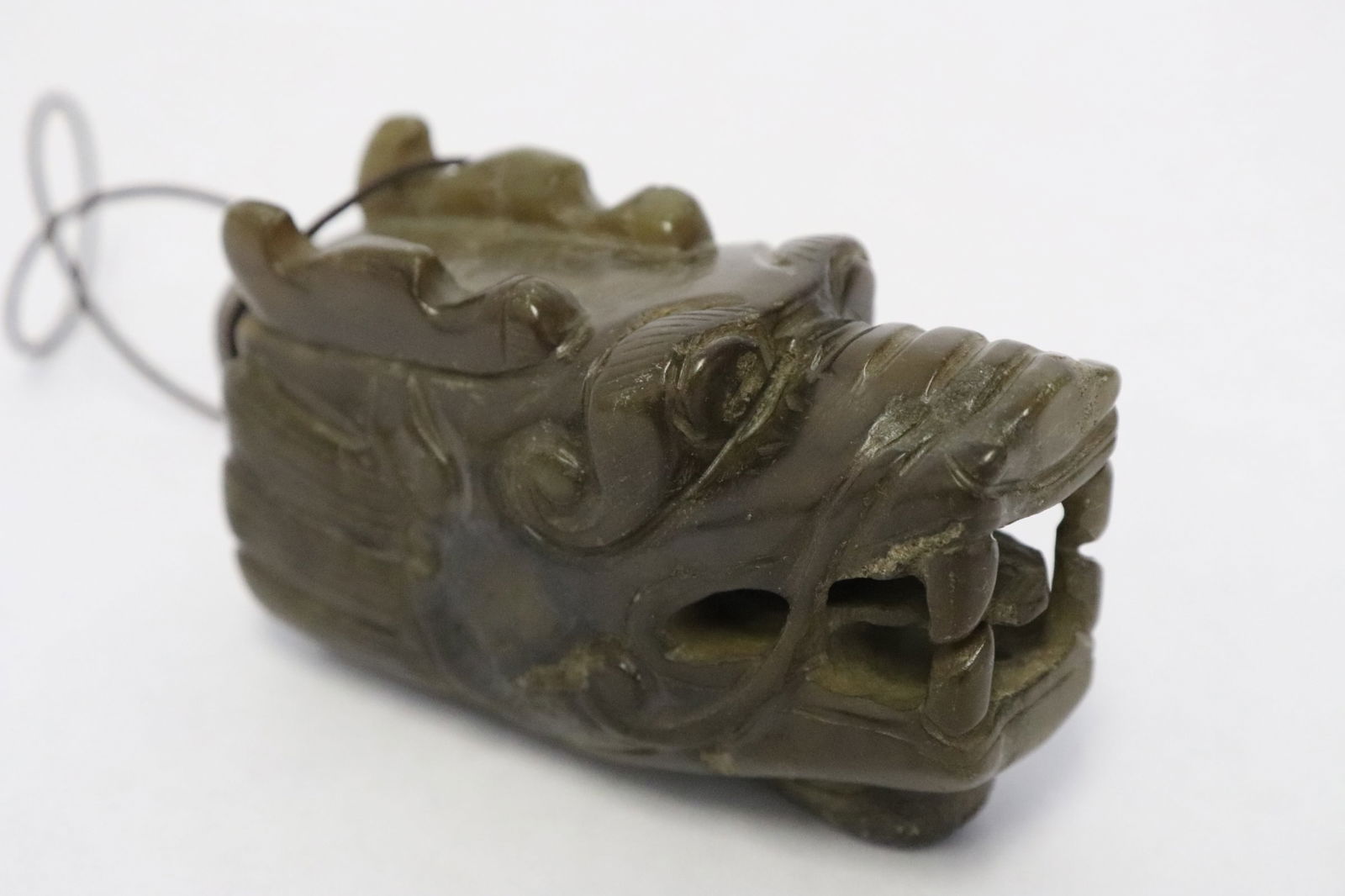 A celadon jade carved ornament: A celadon jade carved ornament, 3.1"L