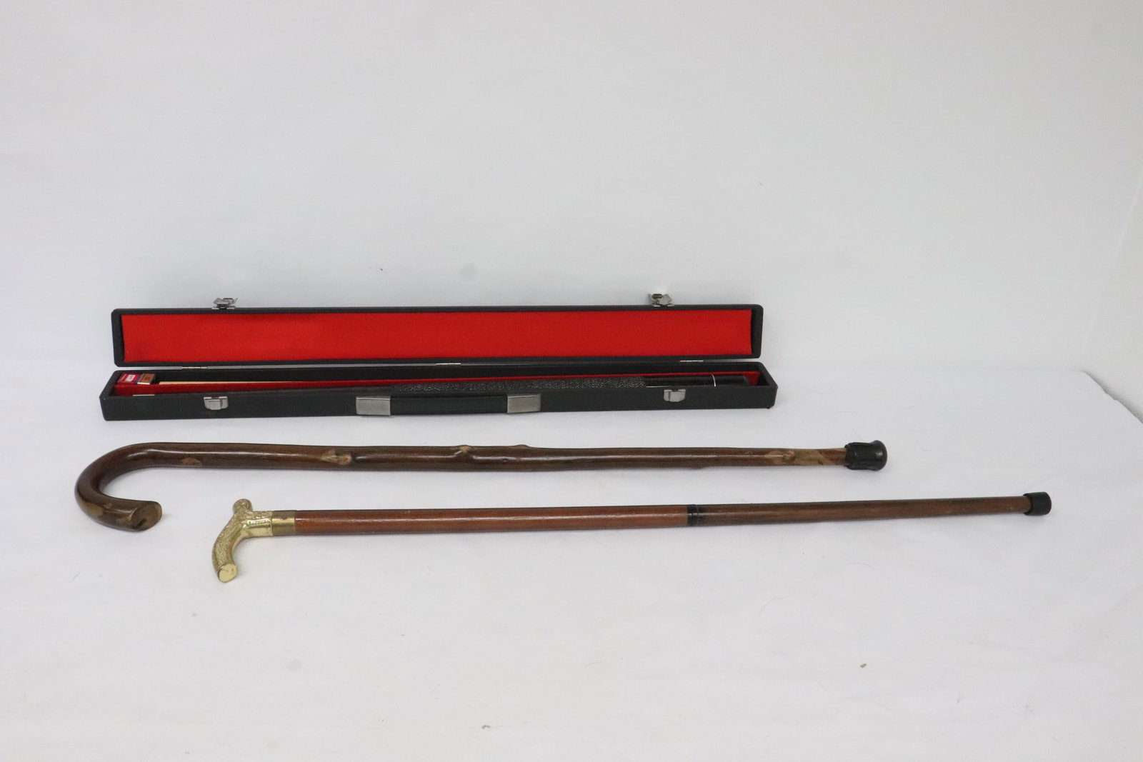 A cue ball stick, and 2 canes: A cue ball stick (58"L) (new in case), and 2 canes (34.2"L, 34"L)