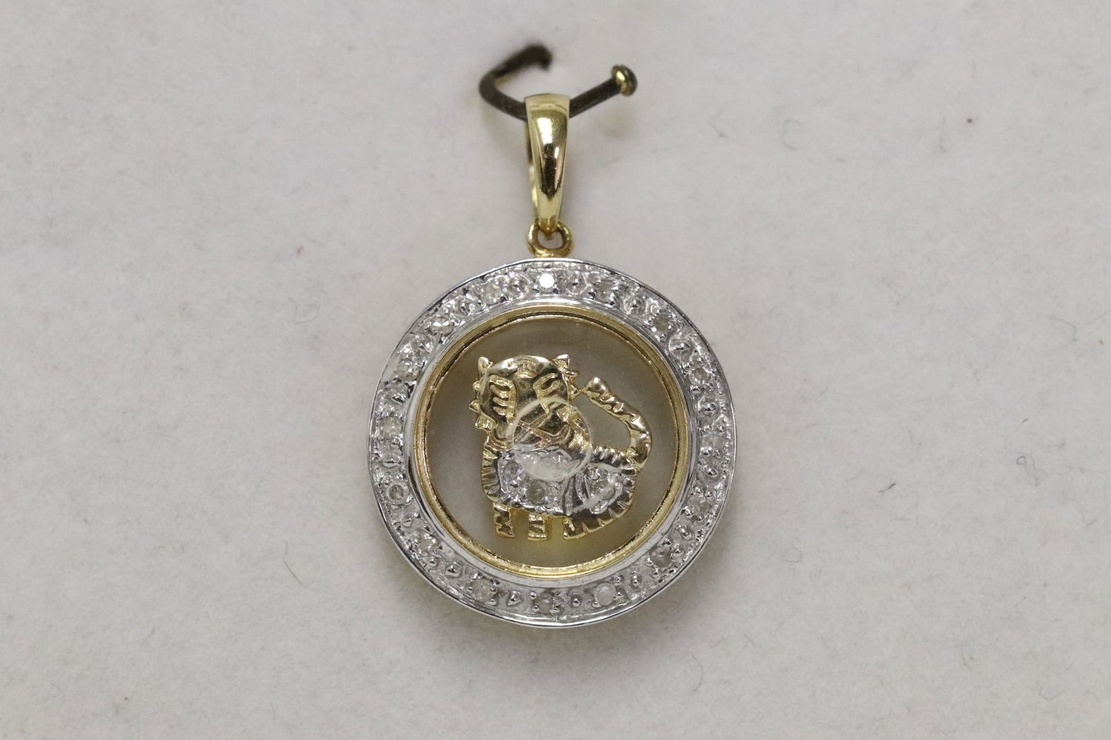 An 18K Y/G pendant with small diamonds (1 of 8)