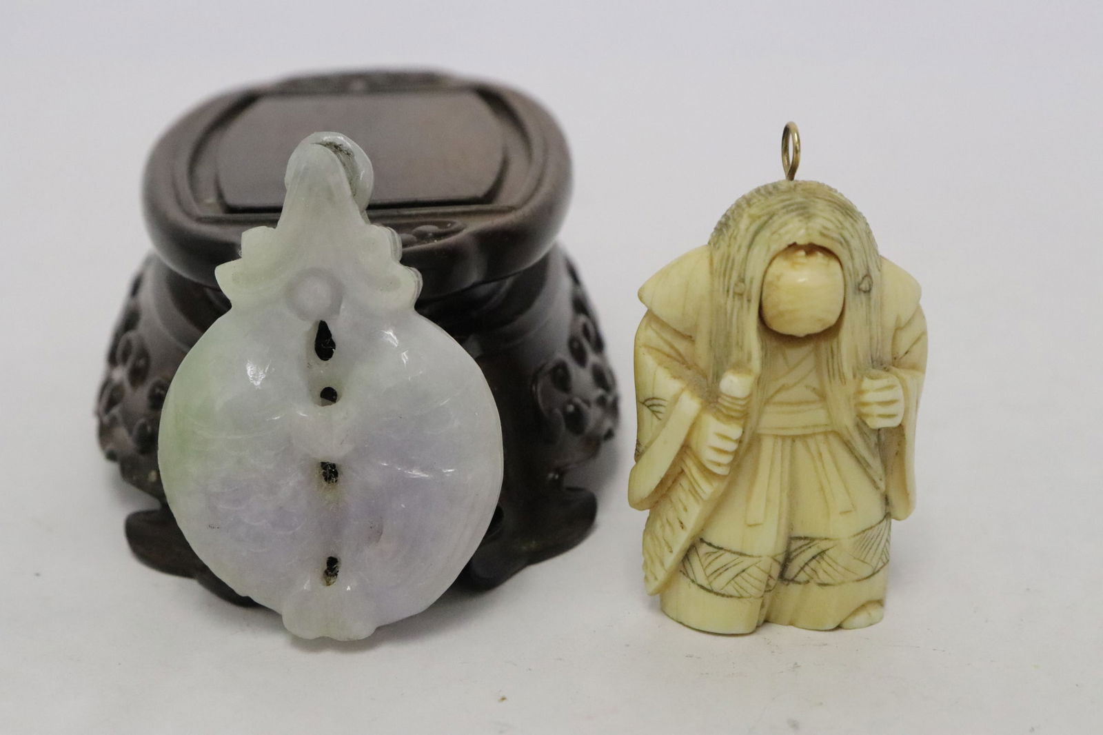 2 pieces: 2 pieces; Japanese bone carved netsuke with rotatable face (1.8"H), and a lavender jadeite carved double fish motif ornament (1.9"x1.38"x0.38")