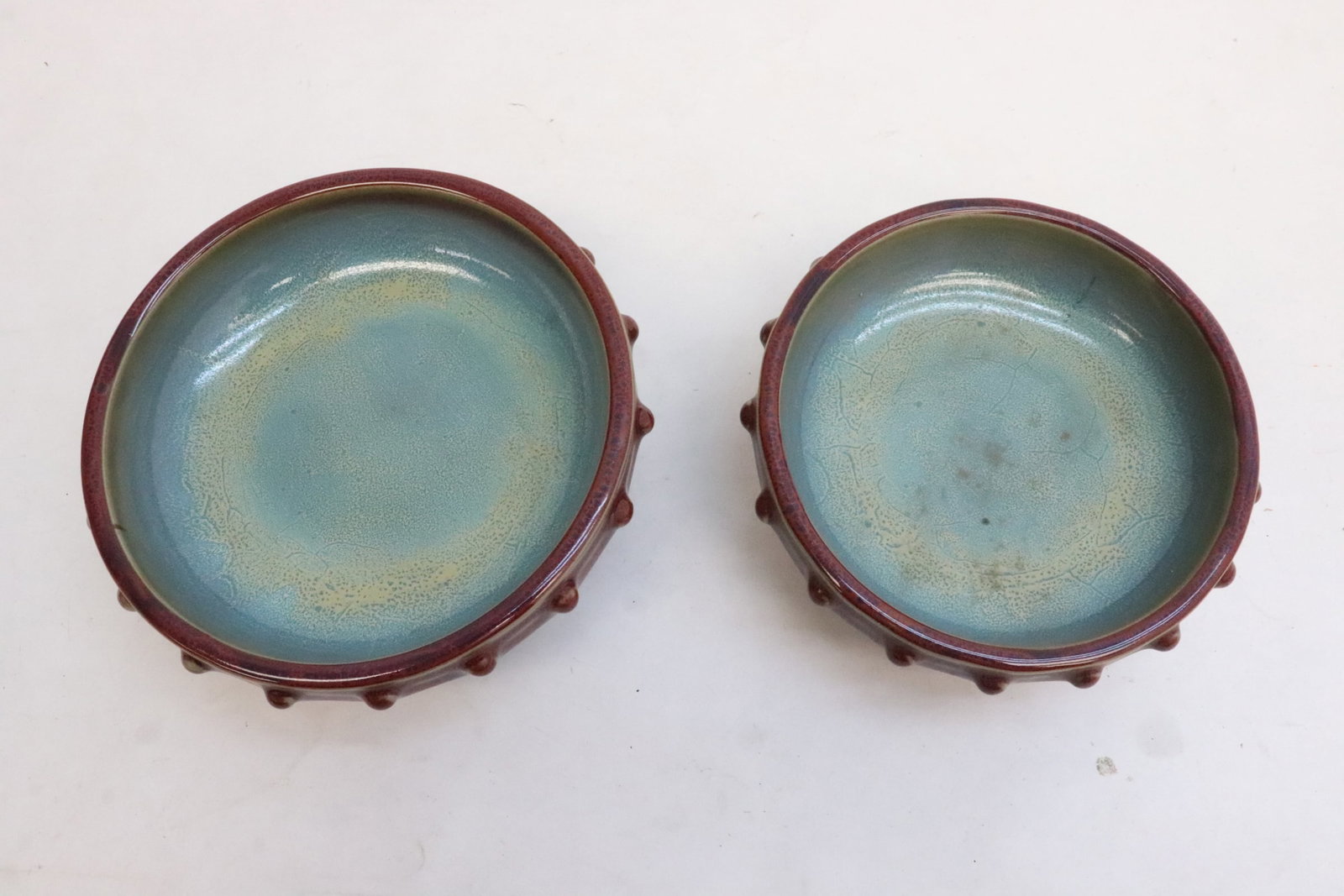 2 red glazed porcelain brush washes: 2 red glazed porcelain brush washes, 2"x5.6"dia, 2.15"x6.15"dia