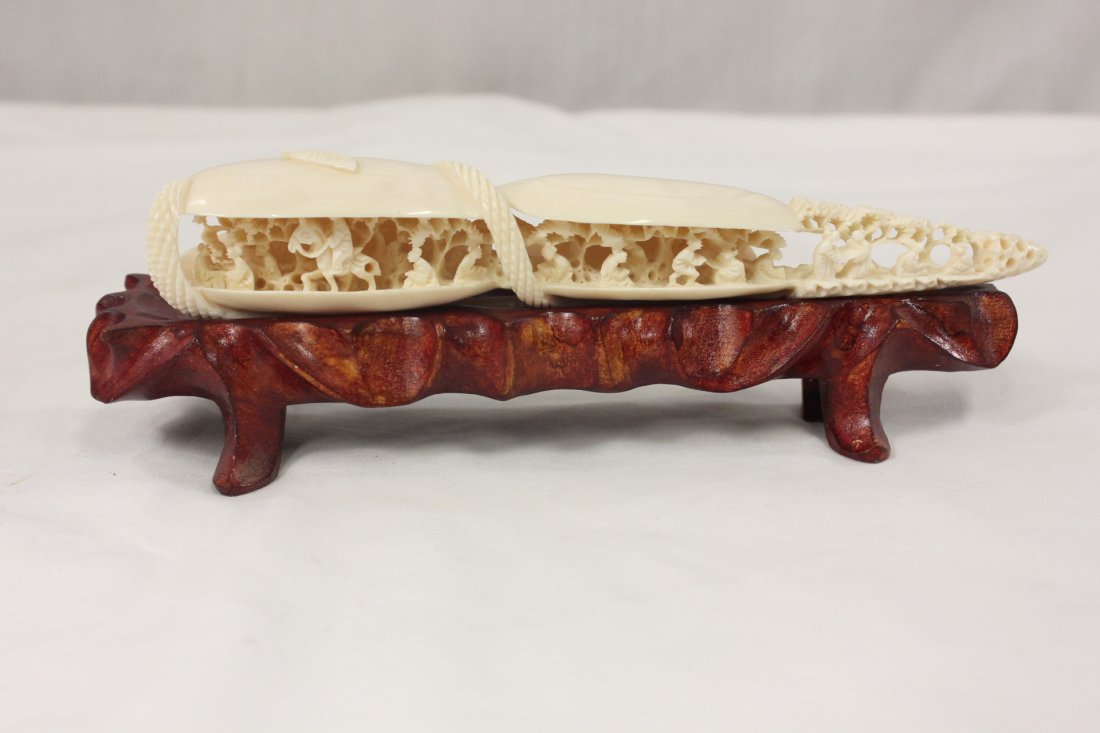 Chinese ivory carving: Chinese ivory carving depicting village scene with landscape and people, 9"Lx1.5"x2"