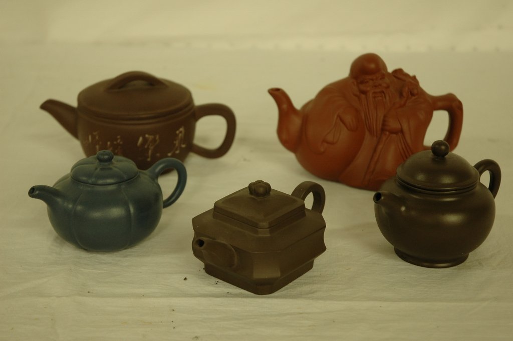5 Yixing clay teapots: 5 Yixing clay teapots (3.1"Hx6.5"x3.8", 3.4"Hx5"x3.3", 2.5"Hx5.4"x3", 3"Hx5"x3.3"), one in sholu motif (4"Hx6.5"x3.5")