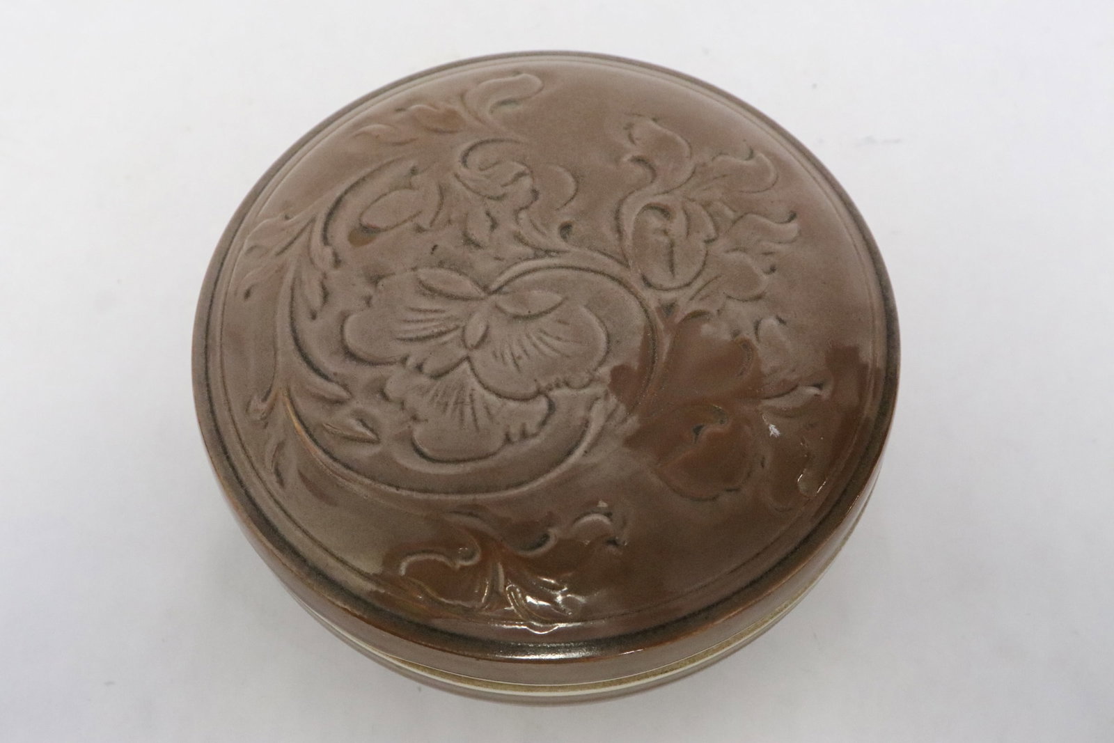 A brown glazed porcelain box: A brown glazed porcelain box, 2.25"x4.8"dia