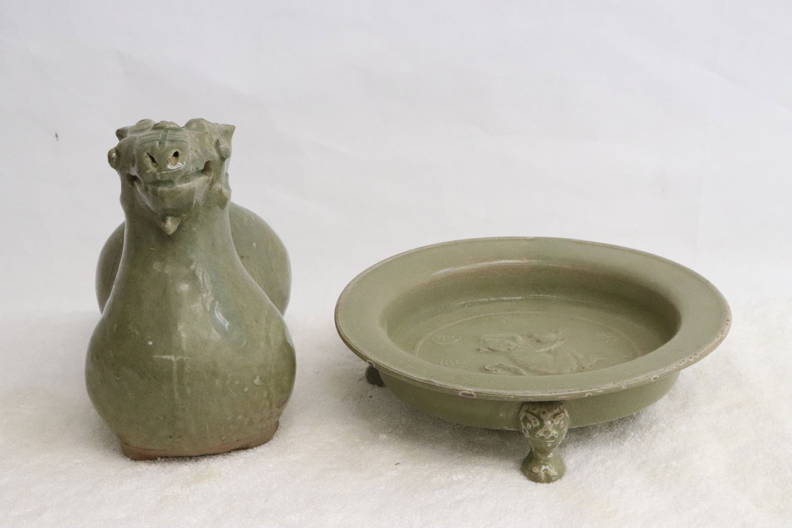 a celadon tripod brush wash, & a celadon camel shape censer: 2 pieces; a celadon tripod brush wash (6.3"H), and a celadon camel shape censer (4.2"x7.65"dia)