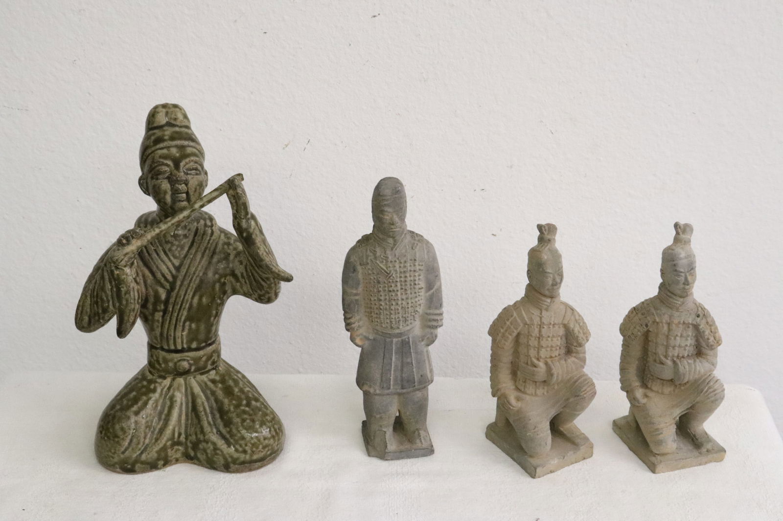 4 earthenware figures, one base chip: 4 earthenware figures, one base chip, 6.8"H - 9.7"H