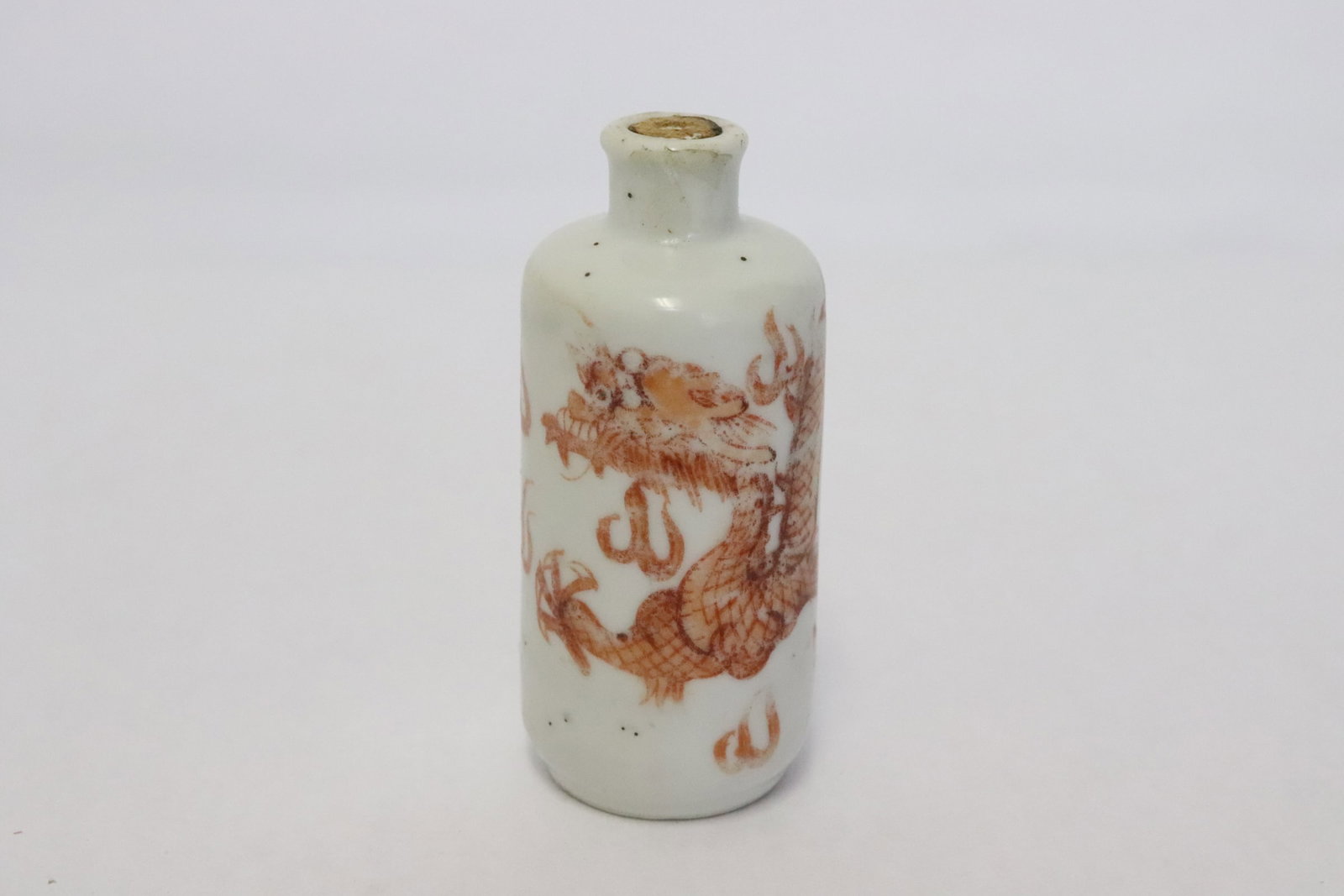 Antique Chinese red & white porcelain snuff bottle: Antique Chinese red and white porcelain snuff bottle painted with dragon motif decoration, 3"x1.3"dia