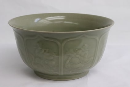 A celadon bowl with decoration in relief