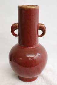 A red glazed porcelain handled vase