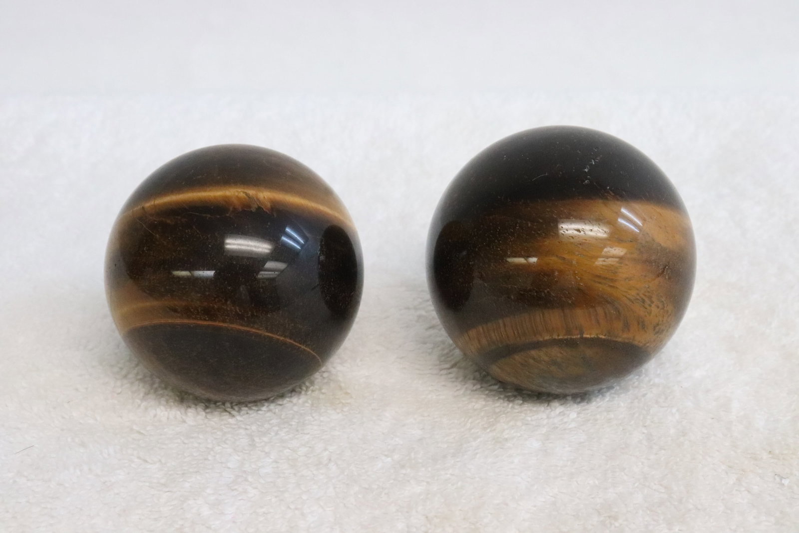 2 tiger eye spheres: 2 tiger eye spheres, 2.15"x2.15"dia, 2.2"x2.2"dia