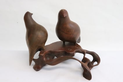 A wood carved bird group