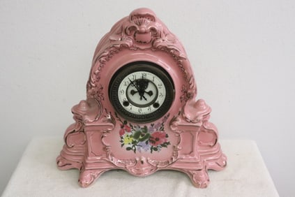 A painted porcelain cased table clock
