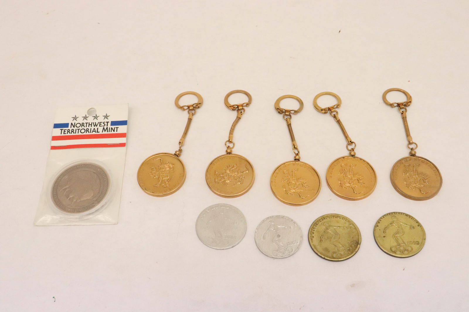 Lot of 1968 Olympic memorabilia coins, and a Northwest Territorial mint coin (1 of 10)