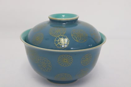 A gold on blue porcelain covered bowl