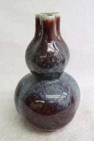 A blue on red gourd shape 3-hole porcelain vase