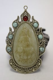 A white bronze pendant with stone carved inset