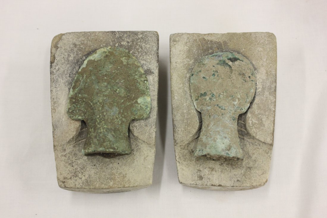 2 antique Luristan/Roman bronze spear heads: 2 antique Luristan or Roman bronze spear heads (4.3"x3"x1.2", 4.2"x2.5"x1") with stone moldings (5.7"x3.9"x2", 5.9"x4.2"x2")