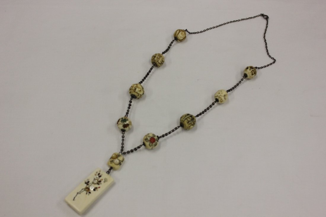 Japanese antique Ojime bead necklace: Magnificent Japanese antique Ojime bead necklace carved in great detail to depict landscape, animal and figures, attached to a shibayama pendent (2"x0.9"x0.4"), total 8 ojimi beads (0.75"dia) (shibaya