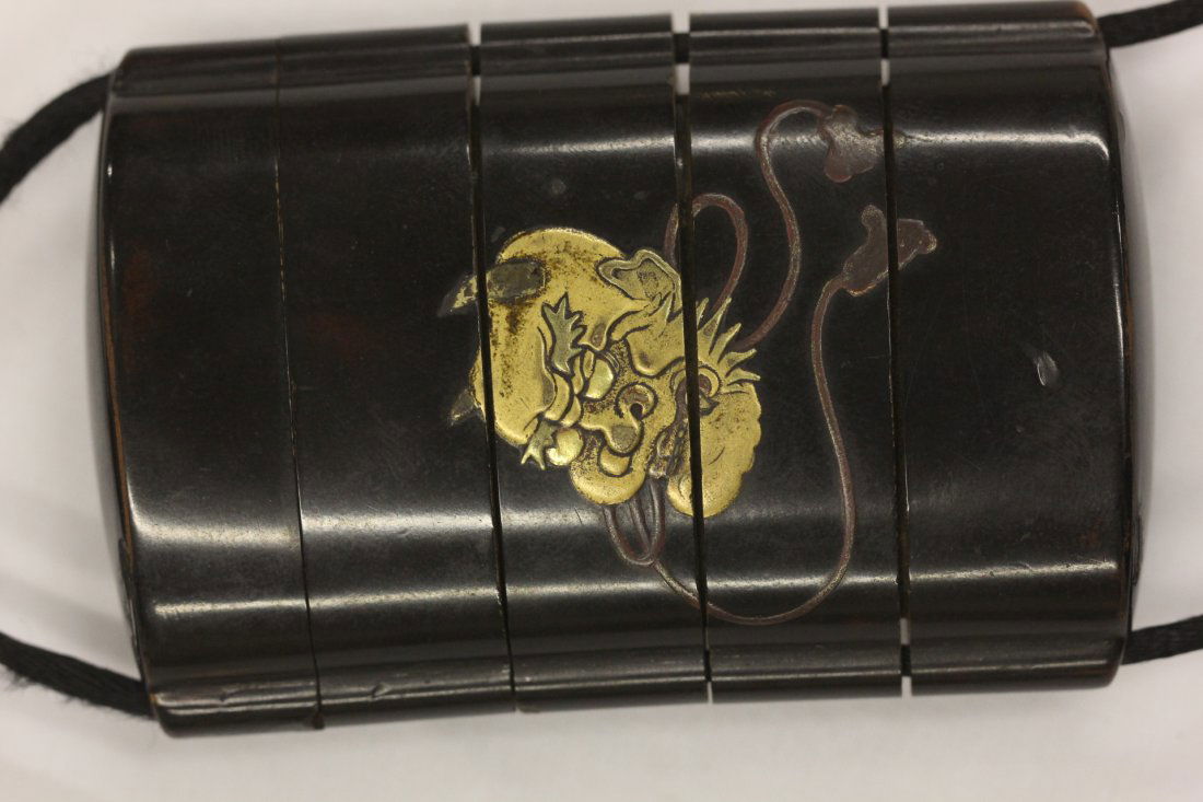 Japanese 4-case lacquer inro: Important Japnese 4-case lacquer inro (3.1"x2"x0.8"), designed in gold and silver takmaki-e with oni face one one side and leaves with fish on the other, interior case nahiji, fitted with a wood carve