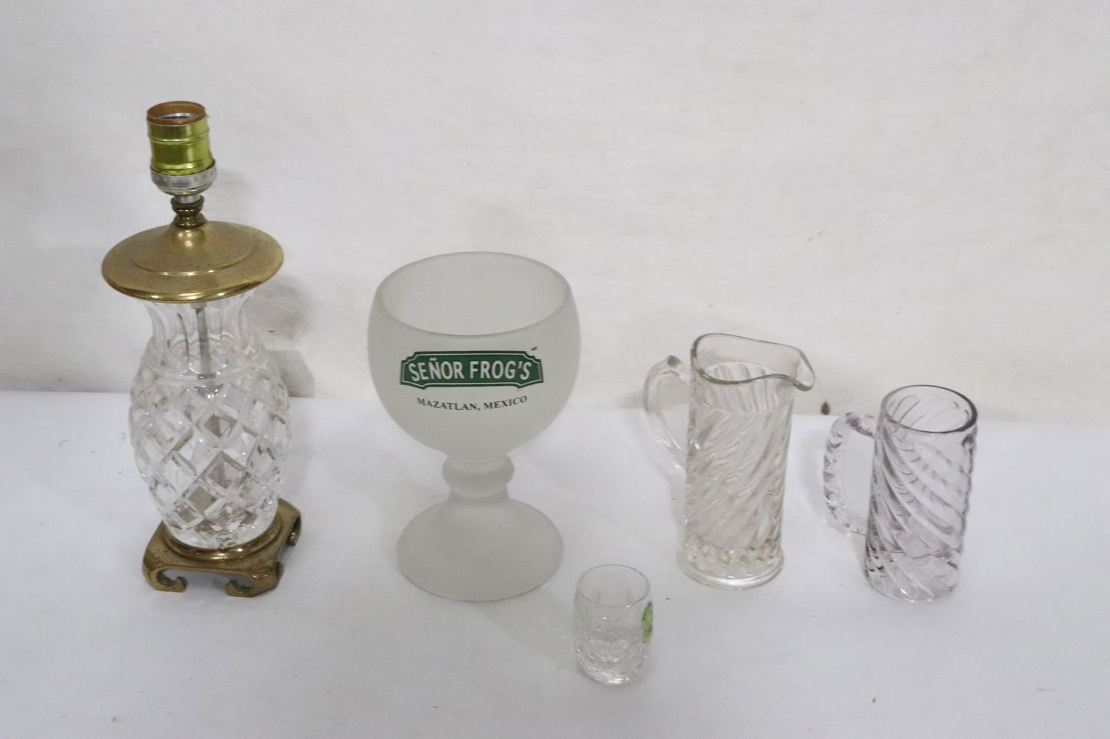 lot of misc.: Waterford shot crystal, Waterford(?) lamp (11.2"H), crystal mug (2.3x1.75"dia), and an advertisement large wine goblet (7.15"x4.8"dia)