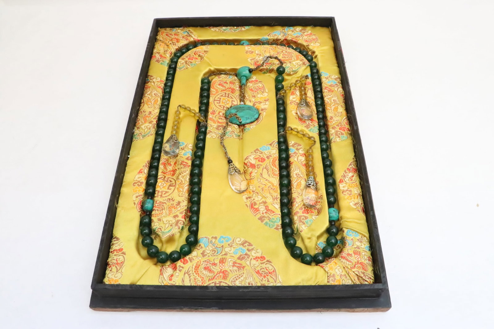 A long necklace in lacquer box: A long necklace (63"L) in lacquer box