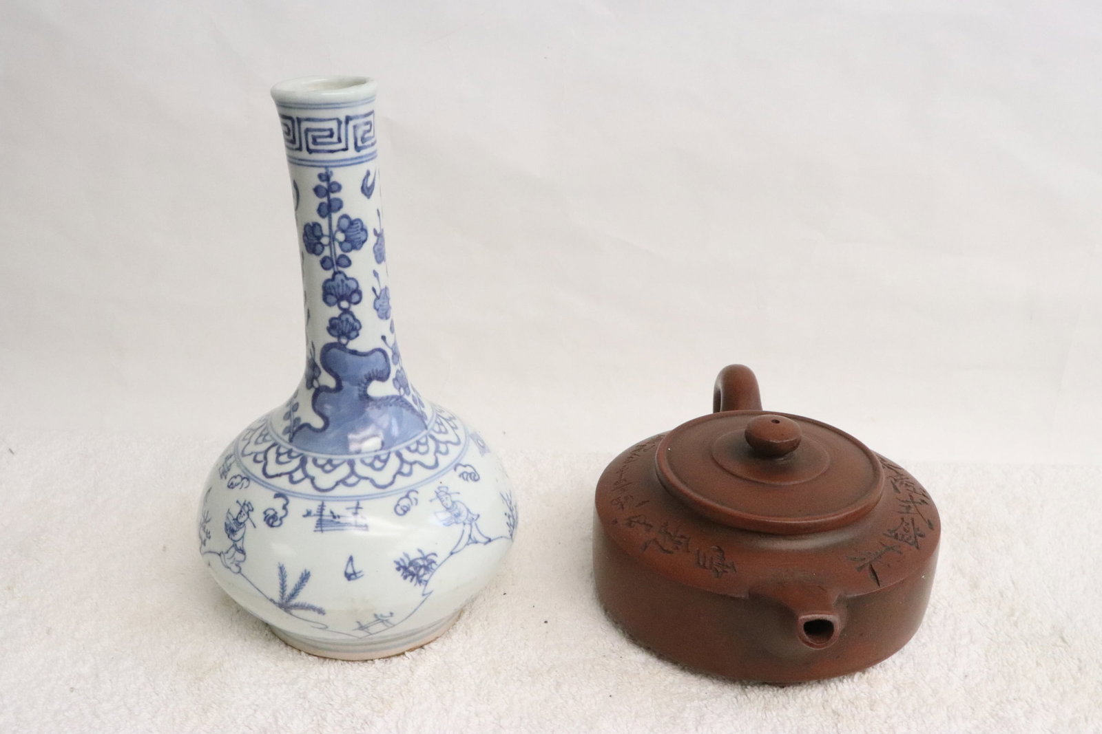 a blue and white porcelain vase, and a Yixing teapot: 2 pieces; a blue and white porcelain vase (7.75"x4.7"dia), and a Yixing teapot (3.1"x7.9"x5.15")