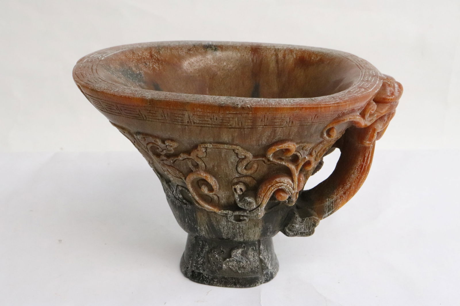 Simulated horn carved libation cup: Simulated horn carved libation cup, 4.25"x6.2"x4.4"