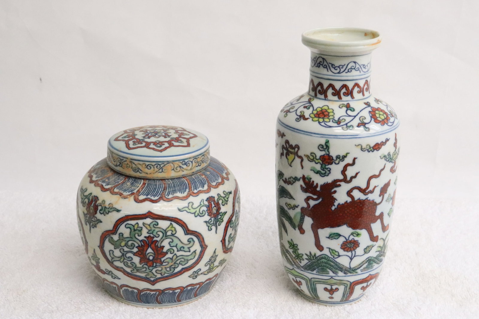 2 wucai porcelain pieces: 2 pieces; a wucai porcelain tea caddy (4.8"x4.76"dia), and a wucai porcelain vase (7.75"x3.5"dia)