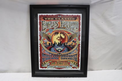 A framed Eagles and fleetwood & Mac concert poster