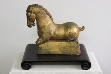 A gilt plaster sculpture on large Chinese wood stand